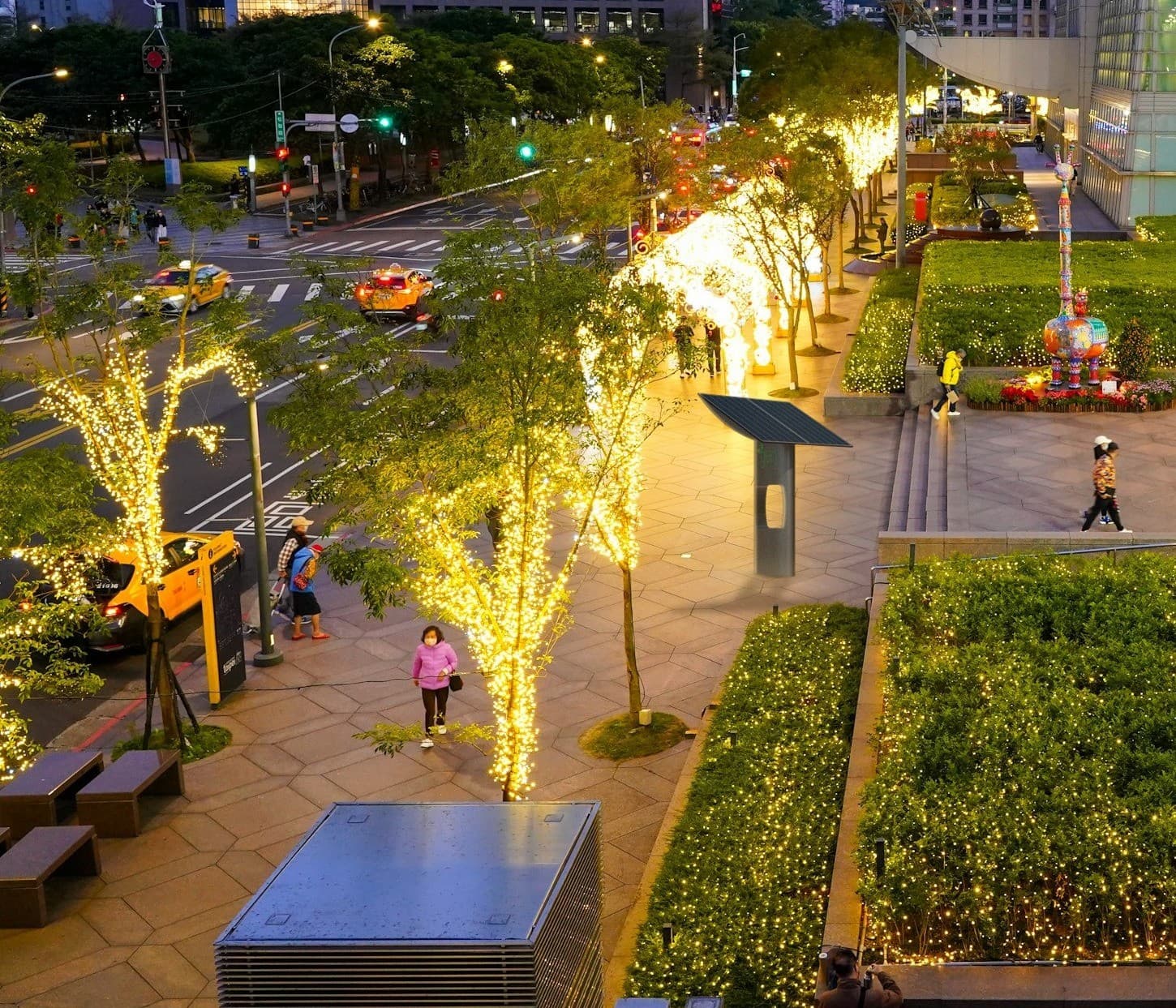 Microgen photovoltaic shelter in the pedestrian plaza of a shopping centre at dusk